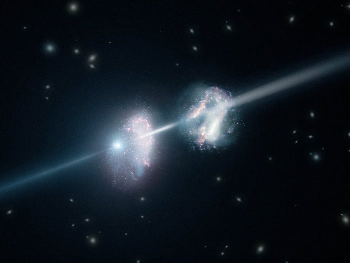 Artist’s impression of a gamma-ray burst shining through two young galaxies in the early Universe
