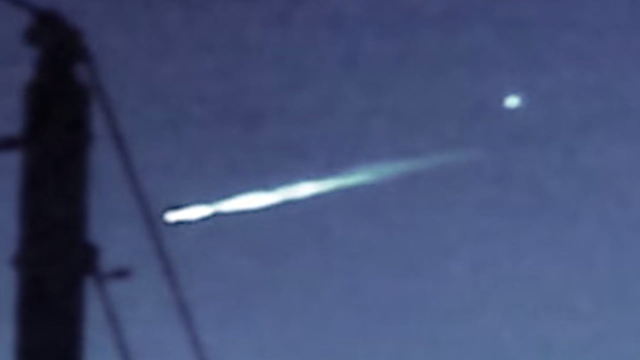 Alleged UFO releasing white orb in sky