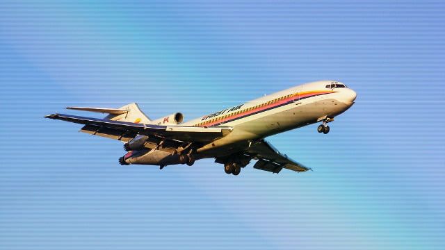 A commercial airliner with a red and blue stripe